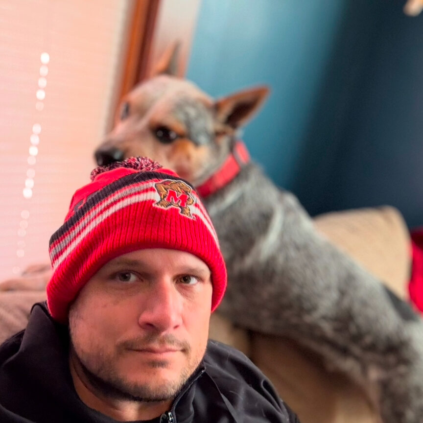 man wearing a hat with a dog