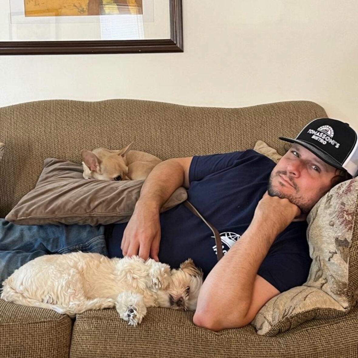 man on a couch with dogs